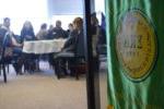 Sigma Kappa Delta green banner with students seated in background